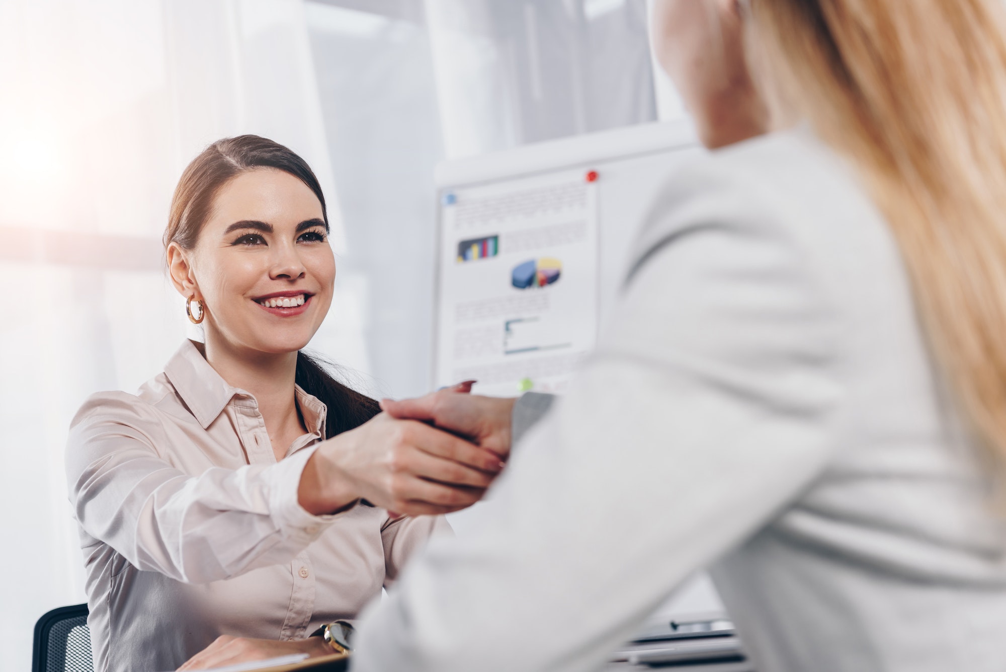 recruiter-smiling-and-shaking-hands-with-employee-at-job-interview-in-office.jpg